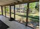 Enclosed tiled patio overlooking a scenic pond with lush landscaping at 375 Woods Landing Trl, Oldsmar, FL 34677