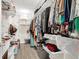 Organized walk-in closet with shelving, hanging rods, and visible clothes and accessories, offering ample storage space at 4654 Pond Ridge Dr, Riverview, FL 33578