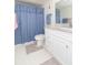 Bathroom with a vanity, granite countertop, and a shower/tub with a blue patterned curtain at 4900 Brittany S Dr # 304, St Petersburg, FL 33715