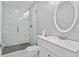 Bathroom featuring a glass shower with marble tile and updated vanity at 5148 23Rd N Ave, St Petersburg, FL 33710