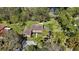 Aerial view of the lovely home nestled in a private, wooded lot with a pond at 5434 Saddlebrook Way # 3, Wesley Chapel, FL 33543