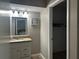 Bathroom featuring a granite countertop vanity and mirror and a walk-in closet at 5434 Saddlebrook Way # 3, Wesley Chapel, FL 33543
