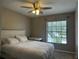 Bedroom with neutral paint, ceiling fan, and a large window overlooking the trees at 5434 Saddlebrook Way # 3, Wesley Chapel, FL 33543