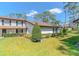 Charming two-story home with manicured lawn and mature landscaping at 5434 Saddlebrook Way # 3, Wesley Chapel, FL 33543