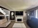 Living room with a white fireplace, modern decor, and staircase to the upper level at 5434 Saddlebrook Way # 3, Wesley Chapel, FL 33543