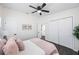 Bright bedroom featuring fresh white walls, dark wood floors, and floral artwork at 5908 N 32Nd St, Tampa, FL 33610