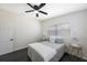 This naturally-lit bedroom has dark floors, a ceiling fan and two windows at 5908 N 32Nd St, Tampa, FL 33610