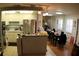 A spacious kitchen features stainless steel appliances, white cabinetry, an island, and a dining area at 6000 20Th N St # 141, St Petersburg, FL 33714