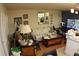 Bright living room with a sofa, mirror reflecting plants, and a TV creates an inviting atmosphere at 6000 20Th N St # 141, St Petersburg, FL 33714