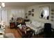 A living room features a patterned sofa, plants in a mirror, and natural light, creating a comfy, inviting space at 6000 20Th N St # 141, St Petersburg, FL 33714