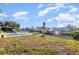 Spacious backyard with an enclosed hot tub, canal access, and plenty of room for outdoor activities at 607 Manatee Ave, Ellenton, FL 34222