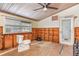 Bathroom featuring partial wood paneling, a ceiling fan, and a toilet at 607 Manatee Ave, Ellenton, FL 34222