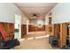 View of an unfinished living room featuring wood paneling and ceiling fan at 607 Manatee Ave, Ellenton, FL 34222