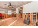 Spacious room under renovation, revealing exposed framing and a peek into the kitchen area at 607 Manatee Ave, Ellenton, FL 34222