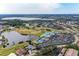 Stunning aerial view of community with golf course, lakes, clubhouse, pool, and tennis courts at 6325 Stone River Rd, Bradenton, FL 34203