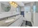 Elegant bathroom featuring double sinks, granite countertops, a glass-enclosed shower and neutral tones at 686 Southwest N Blvd, St Petersburg, FL 33702