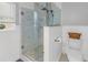 Bright bathroom featuring a tiled walk-in shower with glass doors and modern fixtures at 686 Southwest N Blvd, St Petersburg, FL 33702