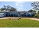 Charming one-story home with a well-manicured lawn and inviting, colorful front door at 686 Southwest N Blvd, St Petersburg, FL 33702