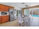 Eat-in kitchen with stainless steel appliances, white countertops, and sliding doors to the backyard pool at 686 Southwest N Blvd, St Petersburg, FL 33702