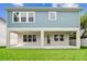 Exterior back of home with a covered patio and spacious yard at 713 W West St, Tampa, FL 33603