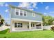 Back exterior of house with covered patio and large grassy lawn, perfect for outdoor enjoyment at 713 W West St, Tampa, FL 33603