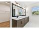 Bathroom with walk-in closet, double sink vanity, quartz countertops and marble tile flooring at 713 W West St, Tampa, FL 33603