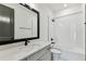 This bathroom has a black framed mirror and shower with white subway tile at 713 W West St, Tampa, FL 33603
