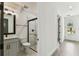 Modern bathroom with glass shower, marble-look tile, and neutral color scheme at 713 W West St, Tampa, FL 33603