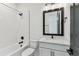 Modern bathroom with a tub-shower combo and sleek black fixtures at 713 W West St, Tampa, FL 33603