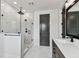 Elegant bathroom featuring a glass shower, modern fixtures and marble tile flooring at 713 W West St, Tampa, FL 33603