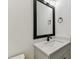 This bathroom has a granite countertop and decorative black framed mirror at 713 W West St, Tampa, FL 33603