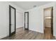 Bright, airy bedroom with wood flooring, modern doors, and access to closet and other rooms at 713 W West St, Tampa, FL 33603