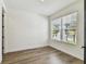 Bright, airy bedroom with wood flooring, a large window, and white walls at 713 W West St, Tampa, FL 33603