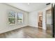 Sunlit bedroom with wood-look flooring and view into en suite bathroom at 713 W West St, Tampa, FL 33603