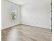 Bedroom with wood floors, large window and ensuite access at 713 W West St, Tampa, FL 33603