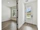 Bright entryway with wood flooring, featuring modern black door hardware and ample natural light at 713 W West St, Tampa, FL 33603