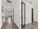 Bright hallway with wood flooring, featuring modern black door hardware and ample natural light at 713 W West St, Tampa, FL 33603