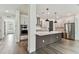 Modern kitchen featuring a large island, stainless steel appliances, and easy access to entry and staircase at 713 W West St, Tampa, FL 33603