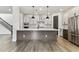 Spacious modern kitchen featuring a large island, stainless steel appliances, and easy access to the staircase at 713 W West St, Tampa, FL 33603