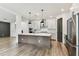 Bright, open kitchen featuring a large island, stainless steel appliances, and stylish pendant lighting at 713 W West St, Tampa, FL 33603