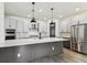 Bright, modern kitchen featuring a spacious island, stainless steel appliances, and pendant lighting at 713 W West St, Tampa, FL 33603