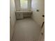 Bright laundry room features geometric tile flooring, sink, and white cabinets at 713 W West St, Tampa, FL 33603