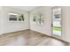 Bright and airy room with hardwood flooring, multiple windows, and a glass door at 713 W West St, Tampa, FL 33603