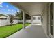 Large covered patio overlooking backyard, perfect for outdoor living, with a blue sky view at 713 W West St, Tampa, FL 33603