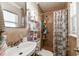 This bathroom features tile walls, shower and tub combination, and a modern sink and faucet at 7701 Jackson Spring Rd, Tampa, FL 33615