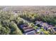 Serene neighborhood aerial view with lush tree coverage, tile roofs and a scenic roadway at 8264 Dunham Station Dr, Tampa, FL 33647