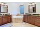 Beautiful bathroom with a soaking tub, granite countertops, and custom vanities for a luxurious feel at 8264 Dunham Station Dr, Tampa, FL 33647