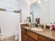 Bathroom featuring a shower with curtain, toilet, and vanity with cabinet space at 8264 Dunham Station Dr, Tampa, FL 33647
