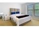 Modern bedroom featuring white walls, a large bed with a tufted headboard and views at 8264 Dunham Station Dr, Tampa, FL 33647