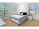 Bright bedroom with large windows, neutral carpet, and a stylish platform bed at 8264 Dunham Station Dr, Tampa, FL 33647